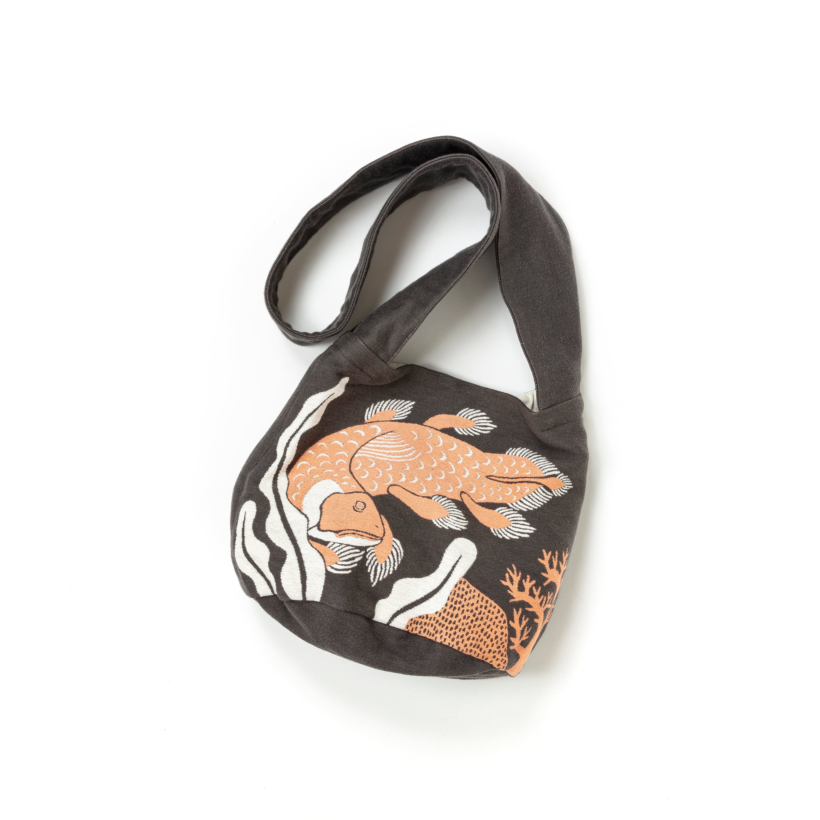 Sling bag with fish design on a white background