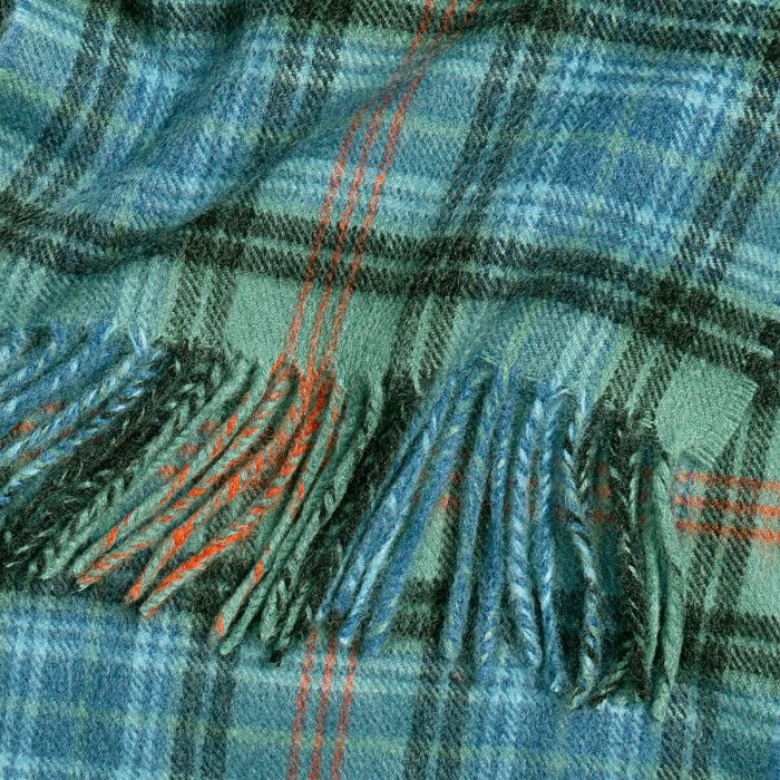 Teal and green plaid wool throw blanket with orange accents and fringed edges.