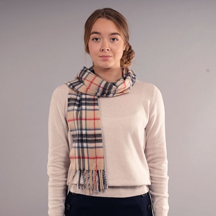 Beige cashmere scarf with a red, black, and navy plaid pattern and fringed edges.