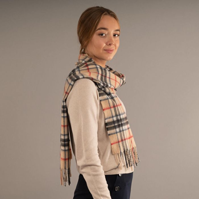 Beige, black, and red plaid wool scarf with fringed edges.