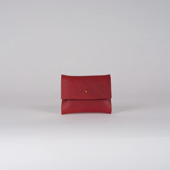 Red leather cardholder with a small gold button closure.