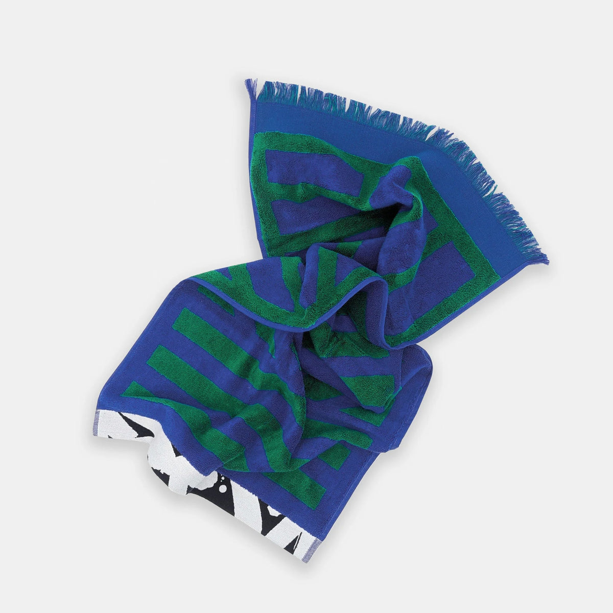 A folded patterned scarf with fringed edges, featuring a blue and green striped design with a black and white geometric border, displayed on a light gray background.