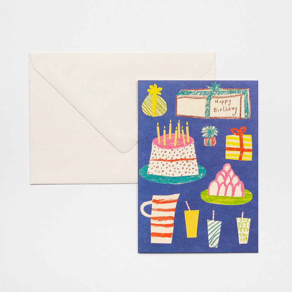 Birthday card featuring a colorful illustration of a cake, presents, and drinks on a dark blue background.