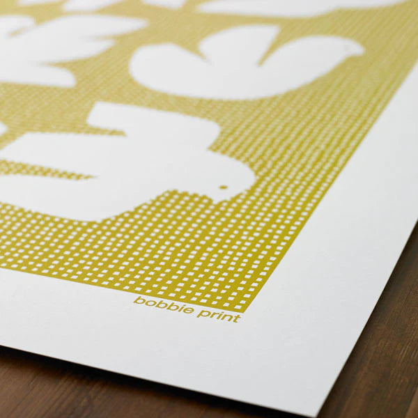 Mustard yellow art print featuring white silhouettes of birds on a textured background.