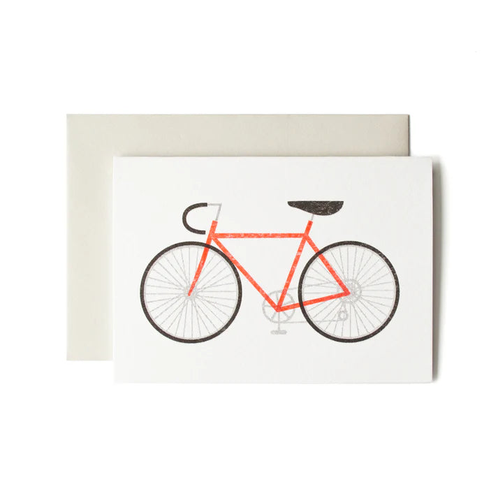 Illustration of a red bicycle on a greeting card.
