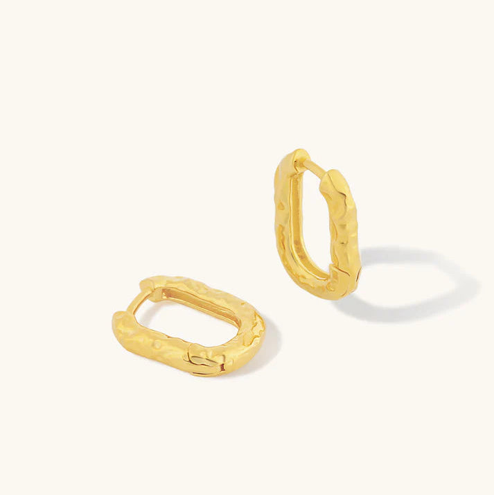 Gold hoop earrings on a white background