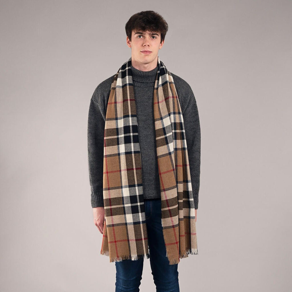 Tan, black, and white plaid scarf with fringed edges.