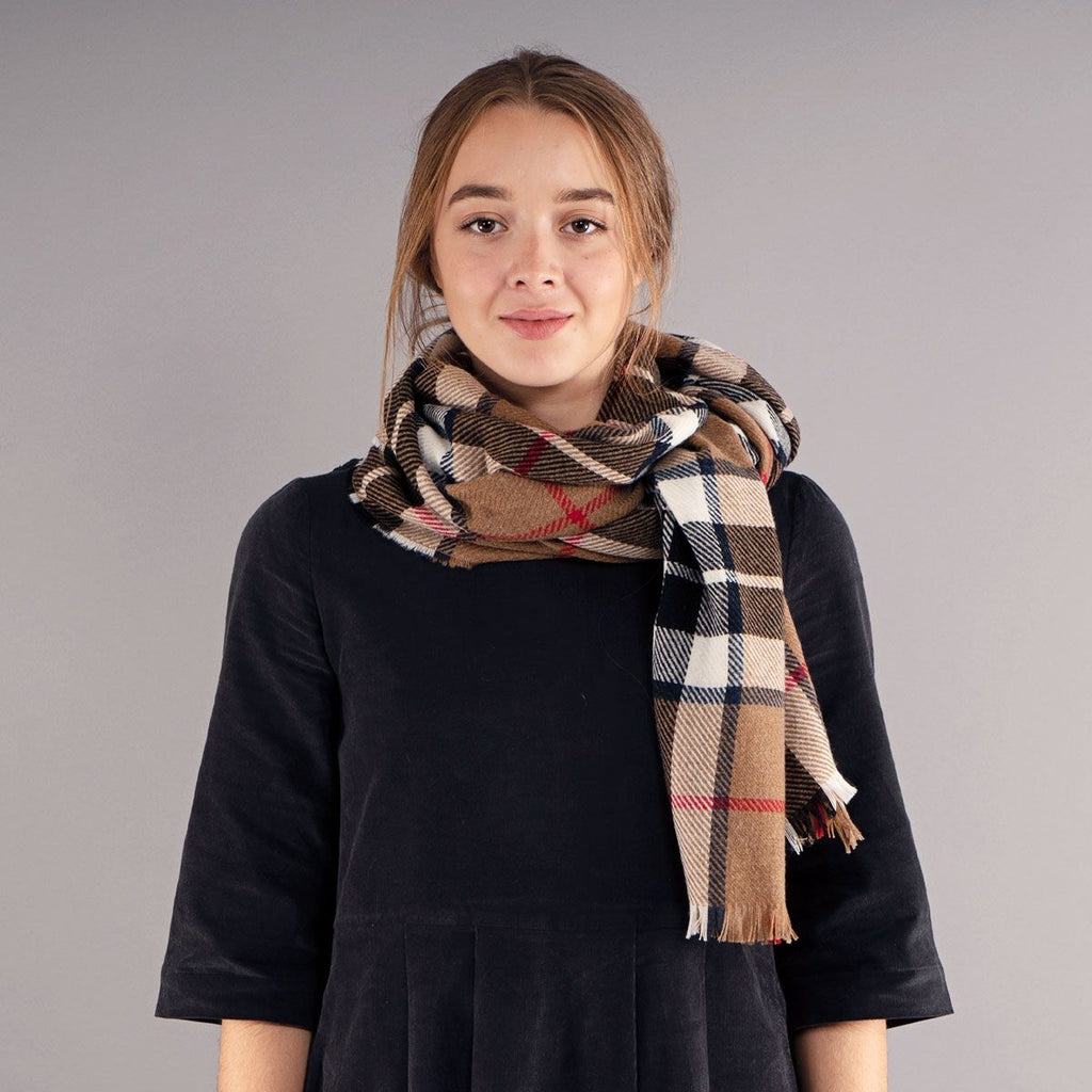 Brown, cream, and navy plaid scarf with frayed edges.