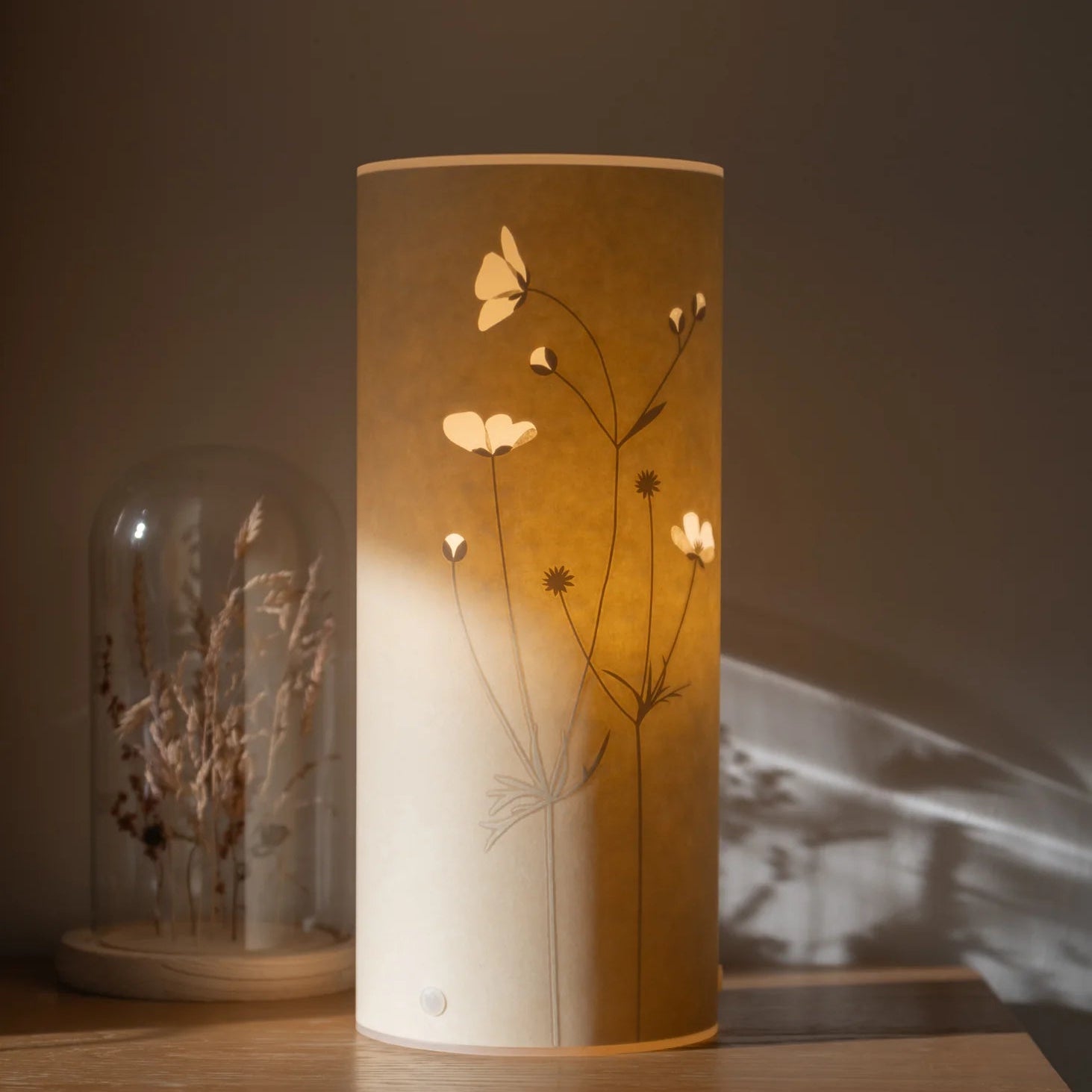 Decorative lamp with floral design on a wooden surface