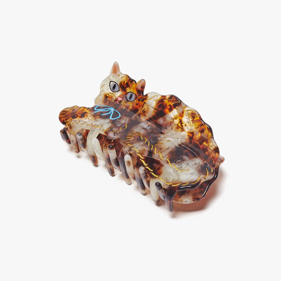 Tortoiseshell patterned cat shaped hair clip on a white background