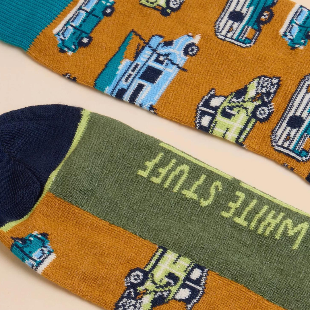 Pair of mustard-colored socks featuring a pattern of vintage camper vans and trucks.