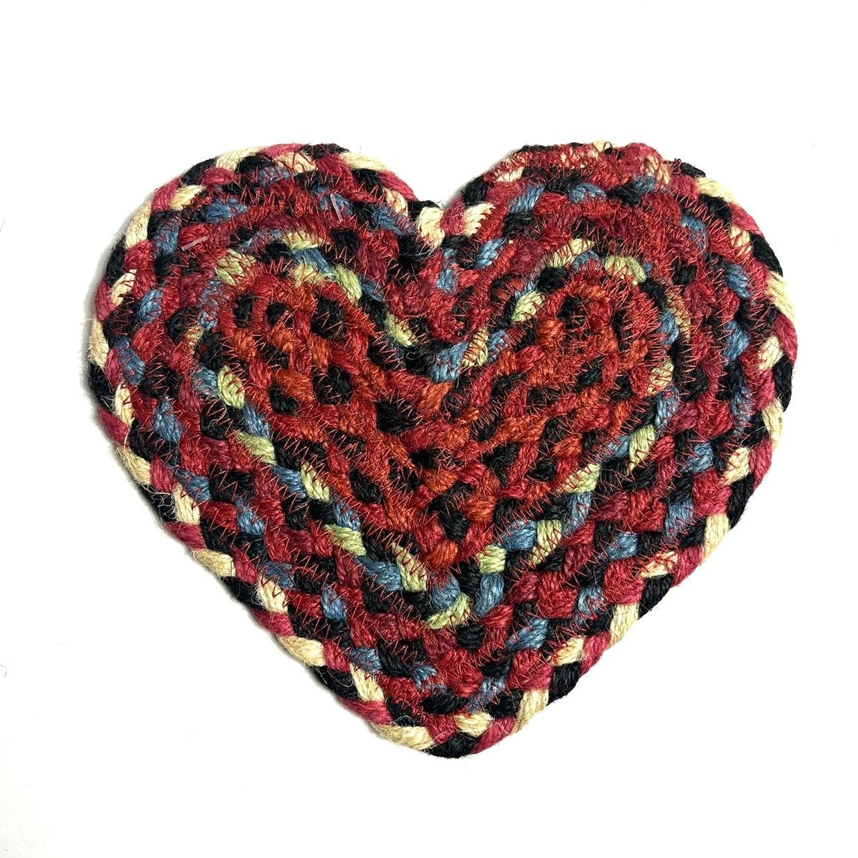 Heart-shaped braided rug in red, black, beige, and blue tones.
