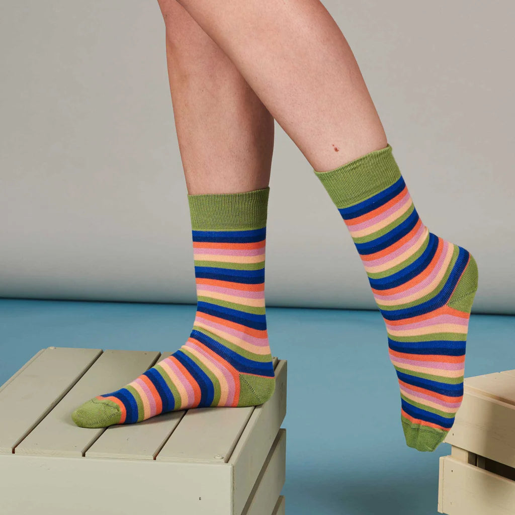 Multicolored striped socks with an olive green cuff.  The stripes include pink, orange, blue, and green.