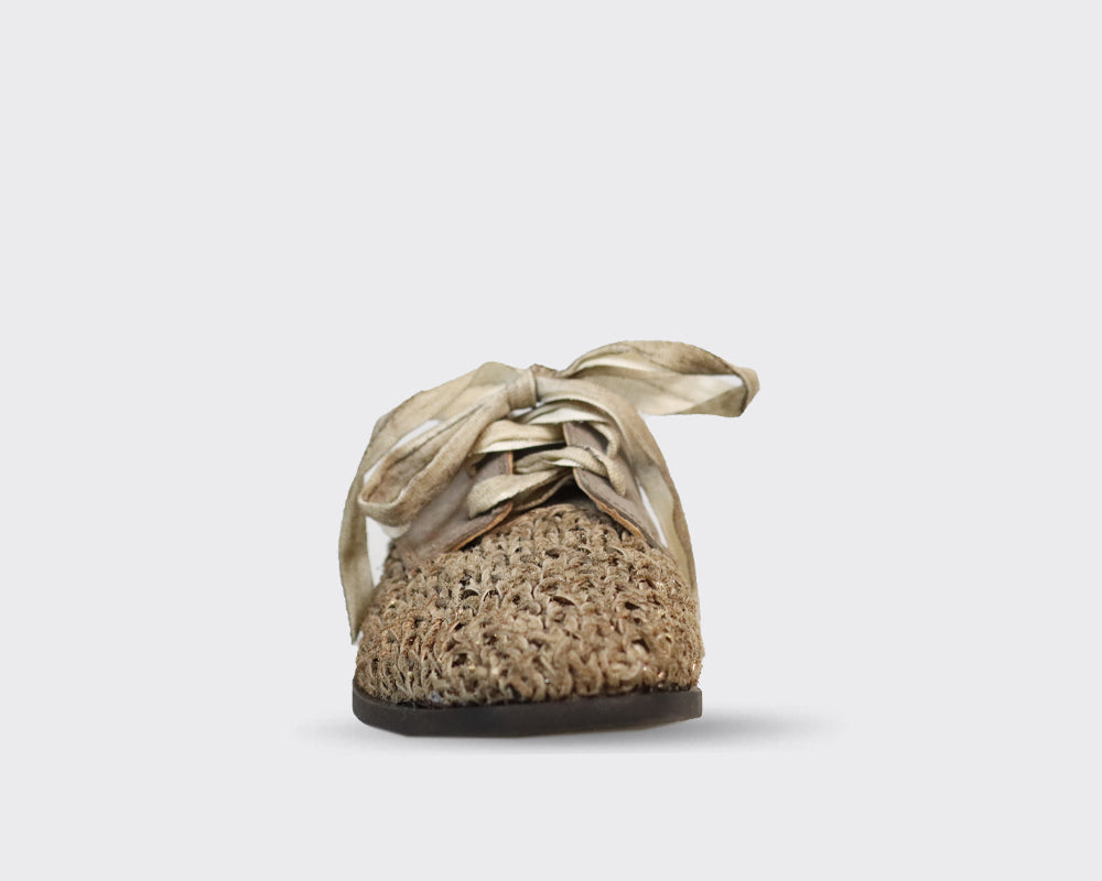 Beige woven-texture shoe with off-white laces tied in a bow.