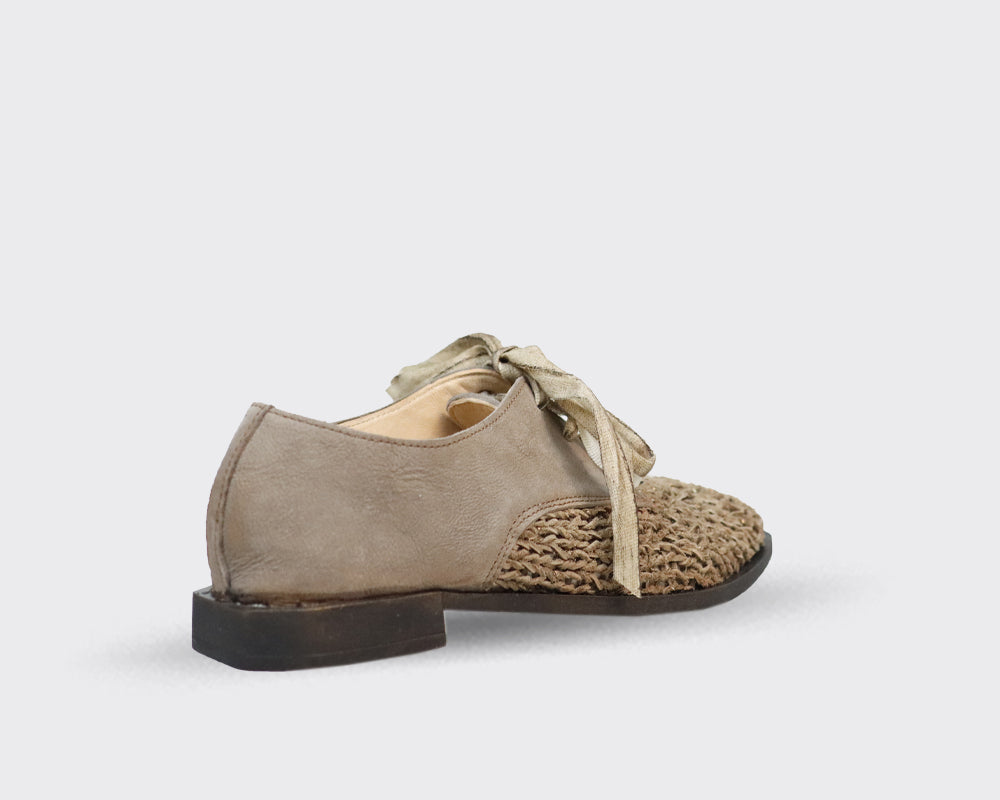 Beige leather and woven textile low-top shoe with light beige laces.