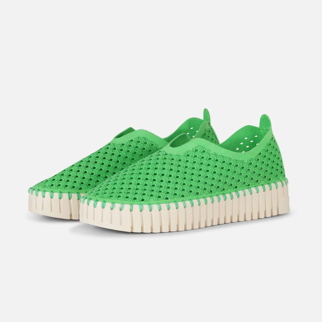 Bright green slip-on shoes with textured, perforated upper and cream-colored, ridged sole.