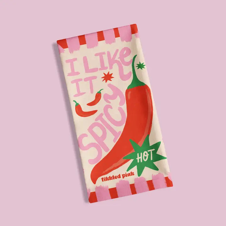 Cream-colored tea towel with pink and red chili pepper design.