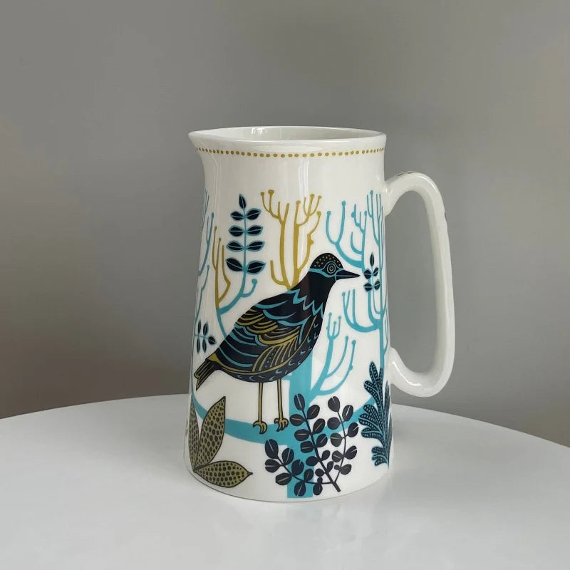 White mug with a bird design on a gray background