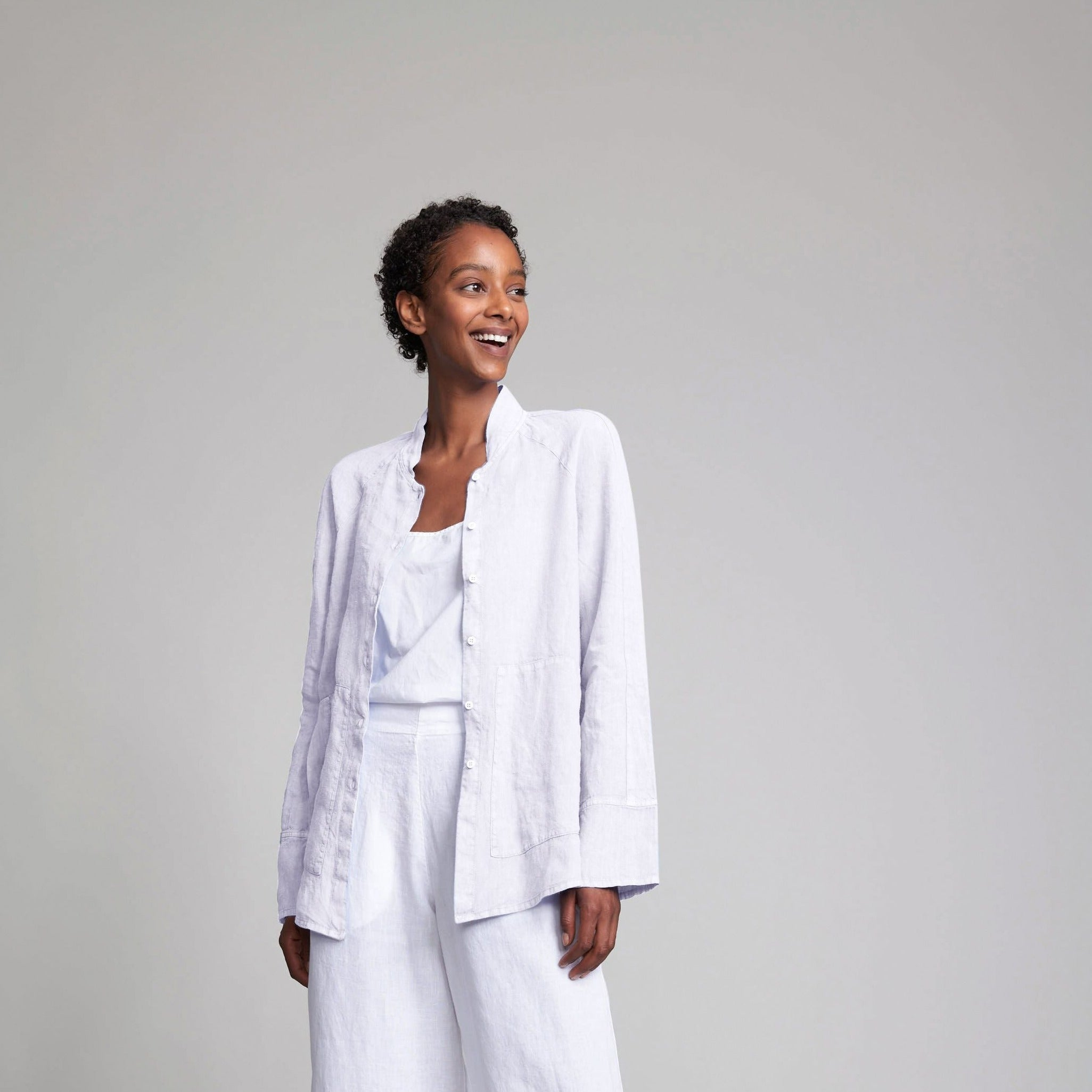 Light lavender linen shirt and wide-leg pants set.  The shirt features a mandarin collar and button closure.