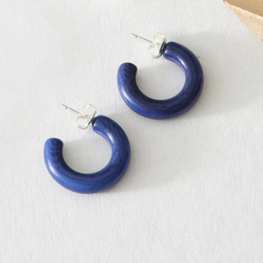 Pair of dark blue resin hoop earrings with silver posts.