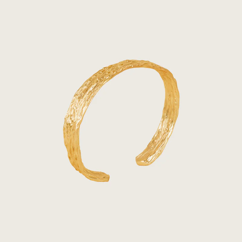 Gold headband on a beige background