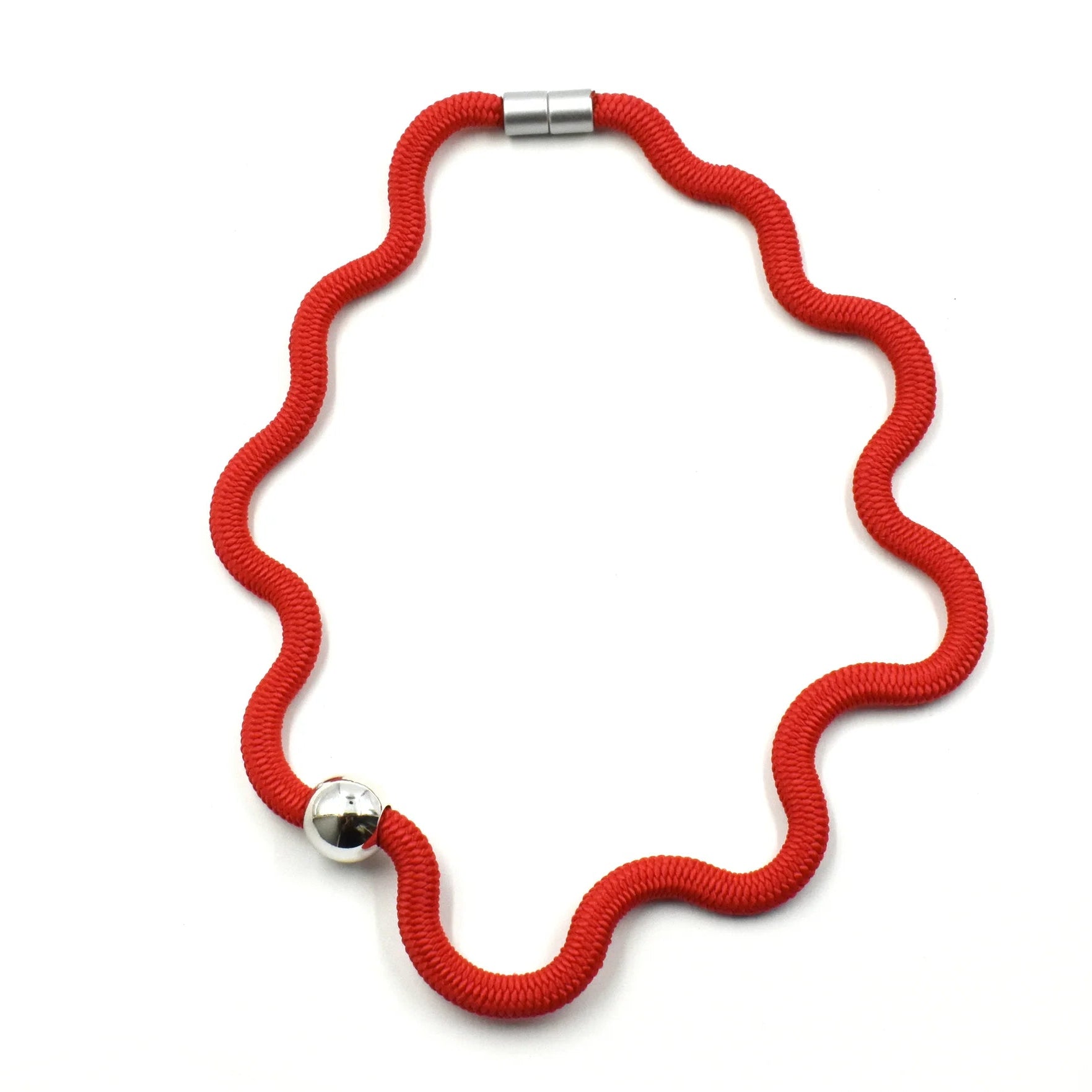 Red cord necklace with silver clasp on a white background