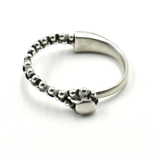 Silver ring with beaded design on a white background