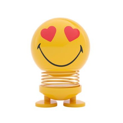 Yellow smiley face bobblehead with hearts for eyes, sitting on a spring.