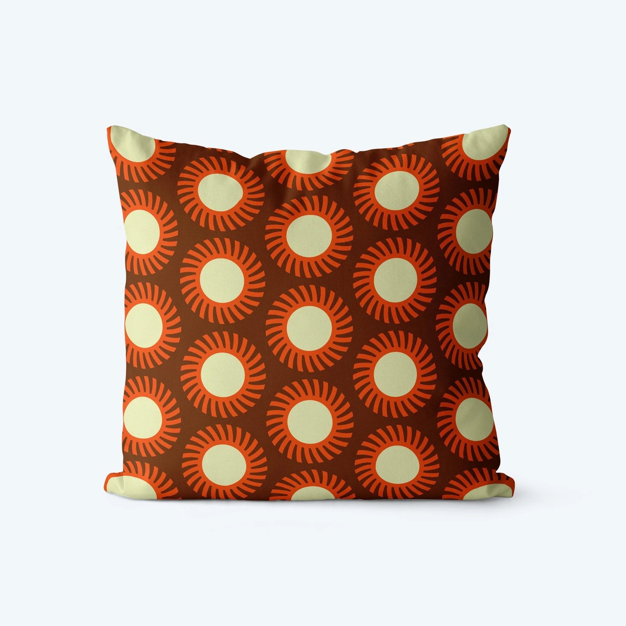 Decorative pillow with sunburst pattern on a brown background