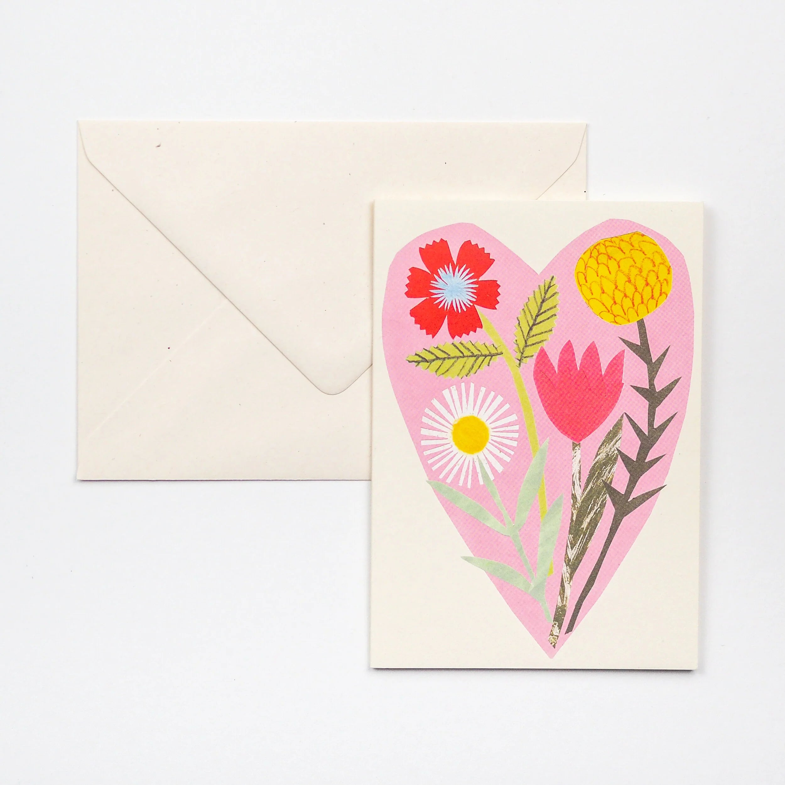 Floral greeting card featuring a pink heart-shaped design containing stylized flowers, including a red poppy, pink tulip,