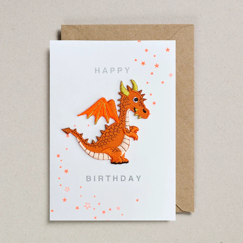 Birthday card with a dragon illustration and 'Happy Birthday' text on a beige background