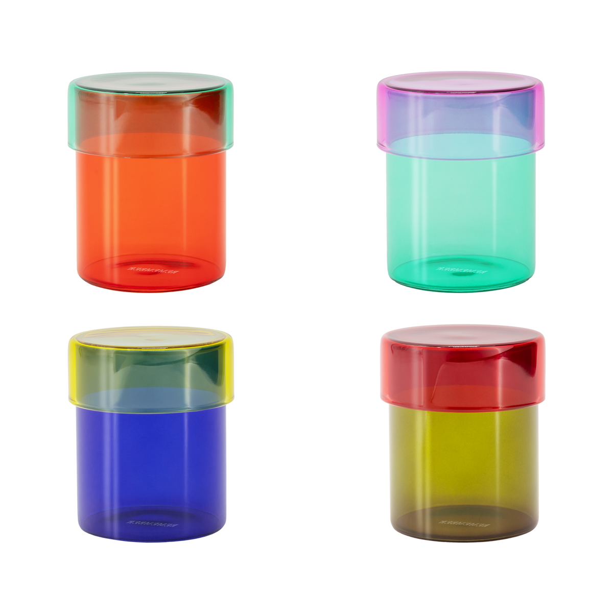 Four small translucent cylindrical containers with colorful semi-opaque lids, arranged in a 2x2 grid on a white background. The containers come in red-orange, mint green, royal blue, and yellow-green color combinations.