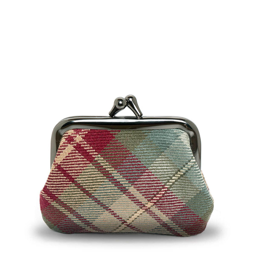 A small, dark-framed purse with a red, green, and beige plaid pattern.