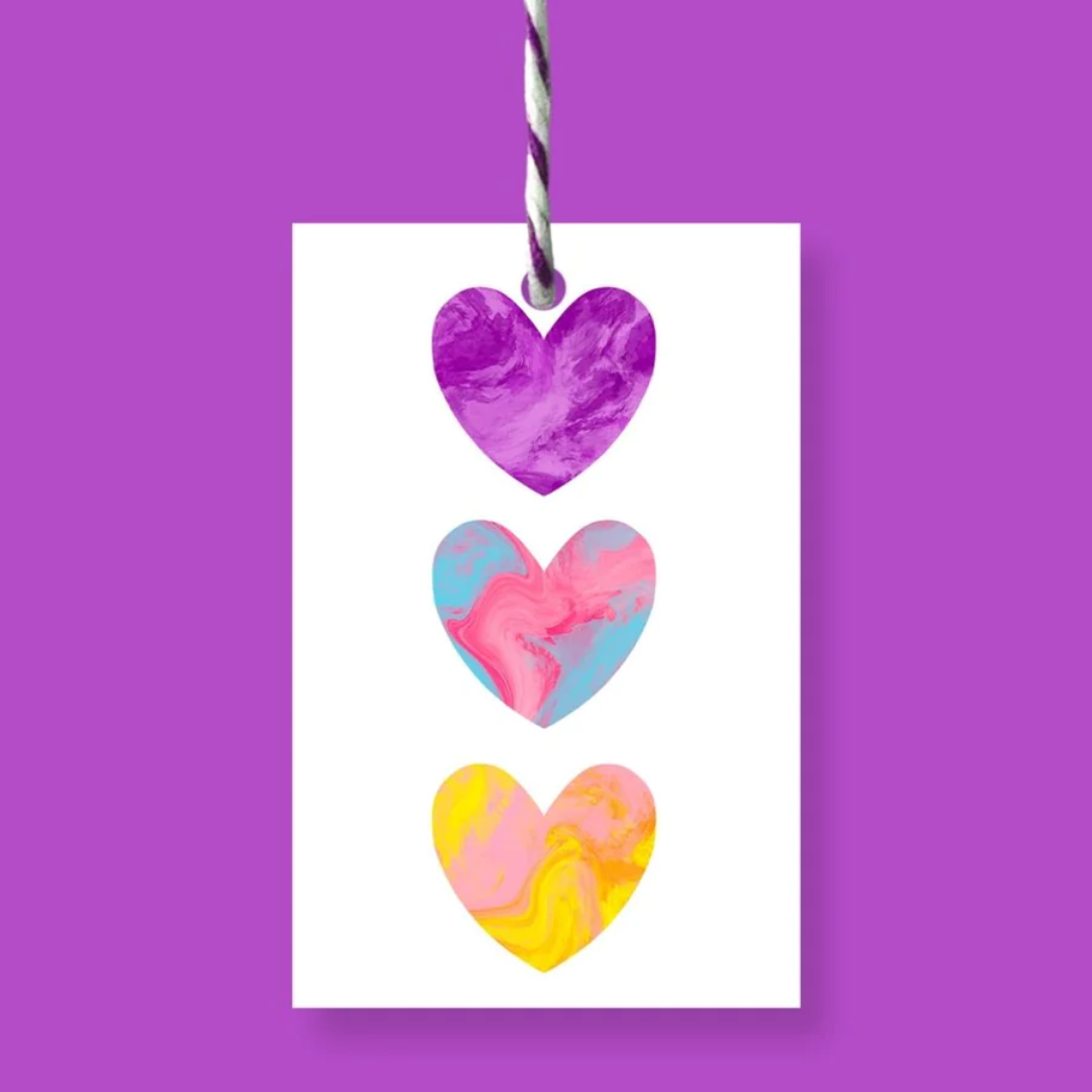 Gift tag with three vertically stacked hearts; each heart features a different pastel marbled design in purple, pink and