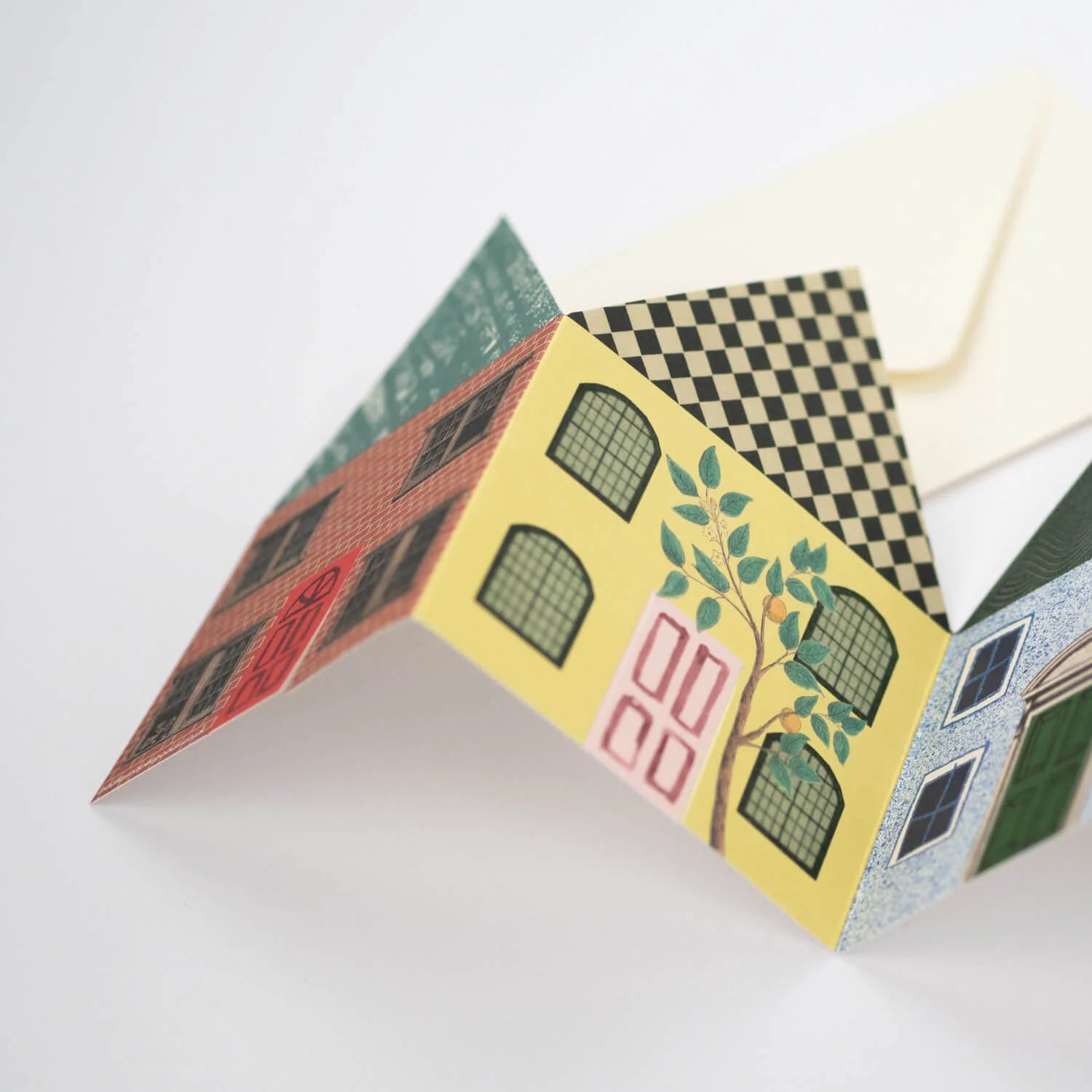 Folded card depicting a row of colorful houses with various architectural details, including windows, doors, and a small