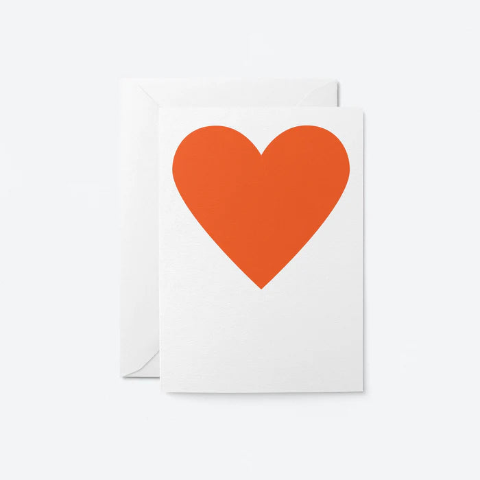 Greetings card with red heart design.