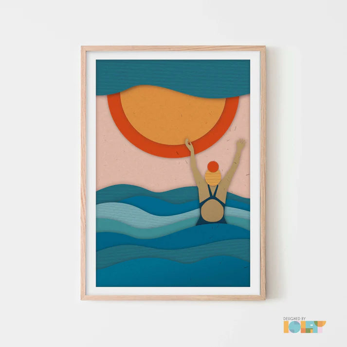 Paper-cut style art print of a swimmer emerging from the ocean under a large sun.