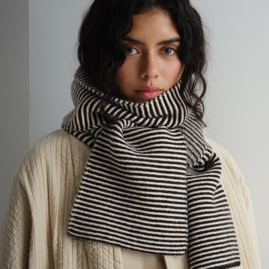 Black and cream horizontally striped knit scarf.