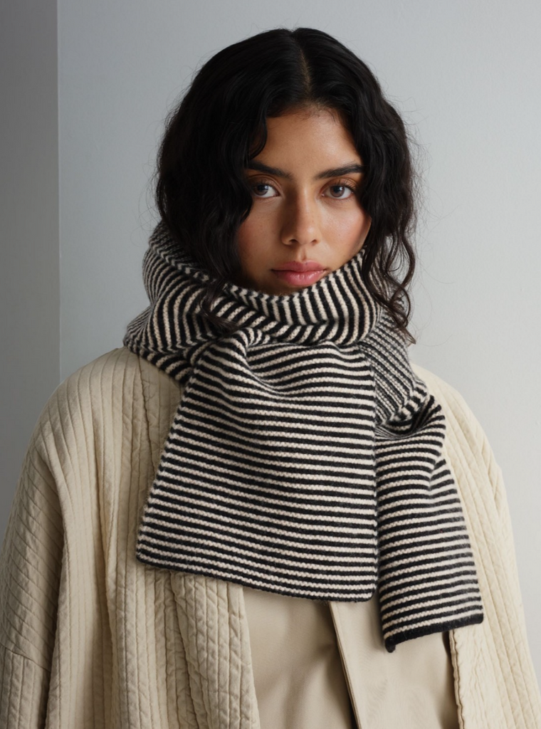 Black and cream horizontally striped knit scarf.