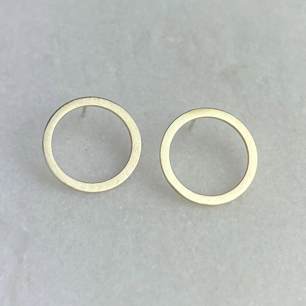 Pair of gold circle stud earrings with a brushed matte finish.