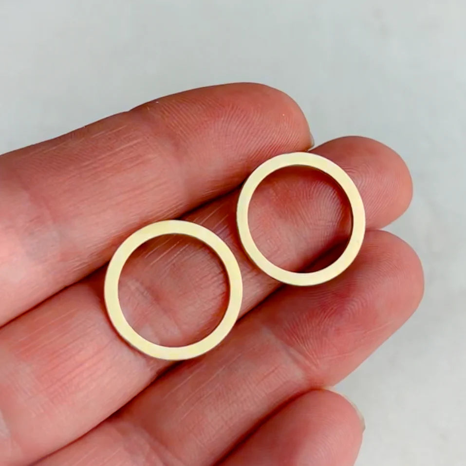 Pair of gold-toned circular earrings; simple, minimalist design.