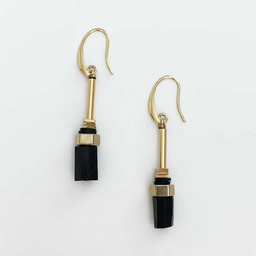 Gold and black earrings on a white background