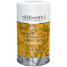 A cylindrical canister of Gilbert's Naturally Delicious Calamari Smokehouse Almonds, featuring a white top lid and a yellow and brown patterned label with almonds.