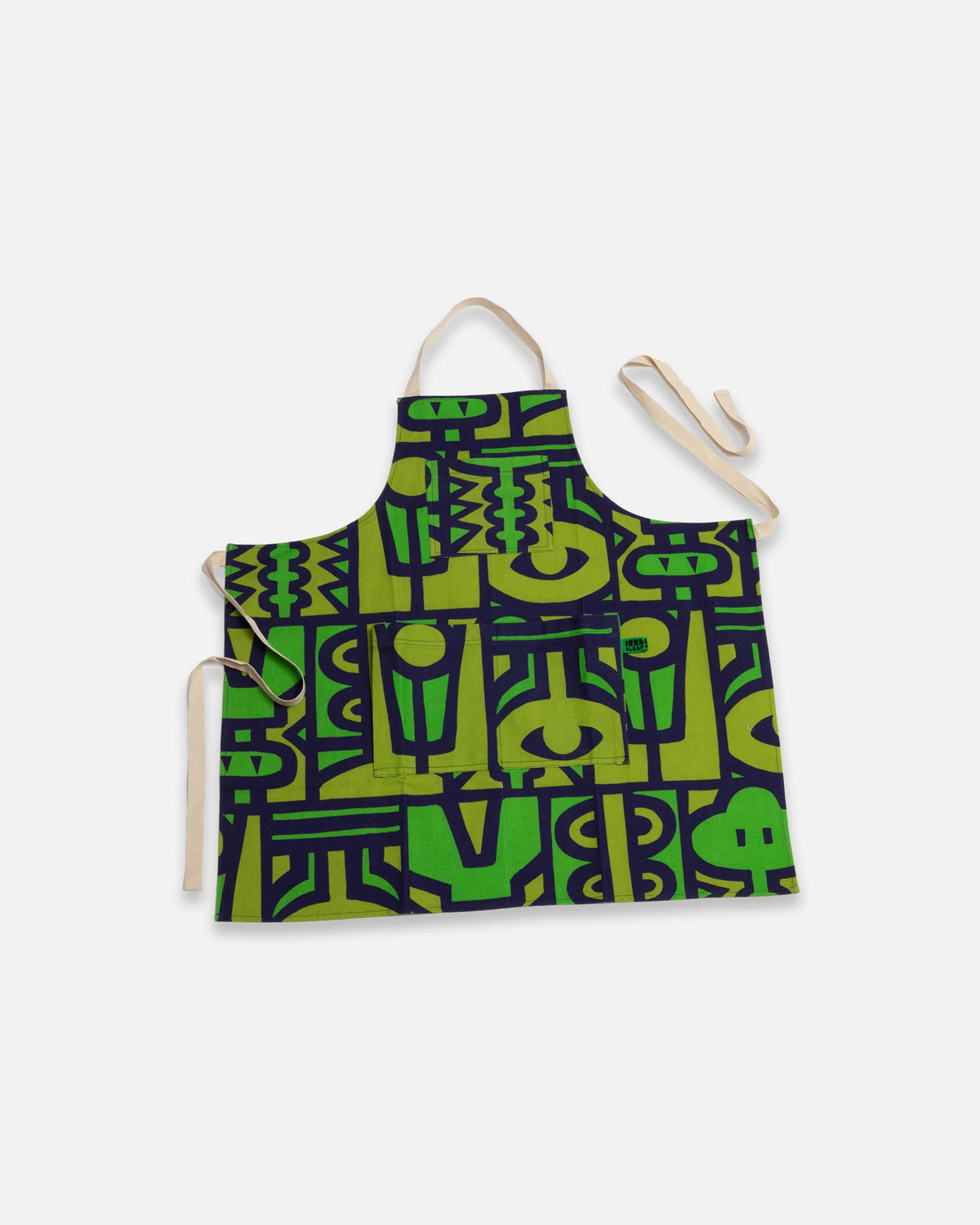 A bib-style apron with a green and black geometric pattern, featuring light beige neck and waist straps, displayed against a light gray background.