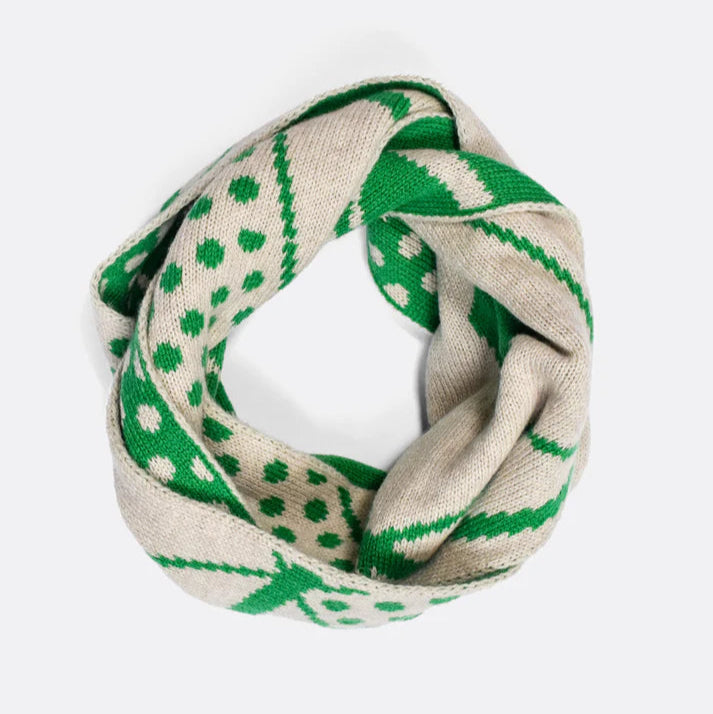 Beige and green knitted infinity scarf with a repeating polka dot and geometric pattern.