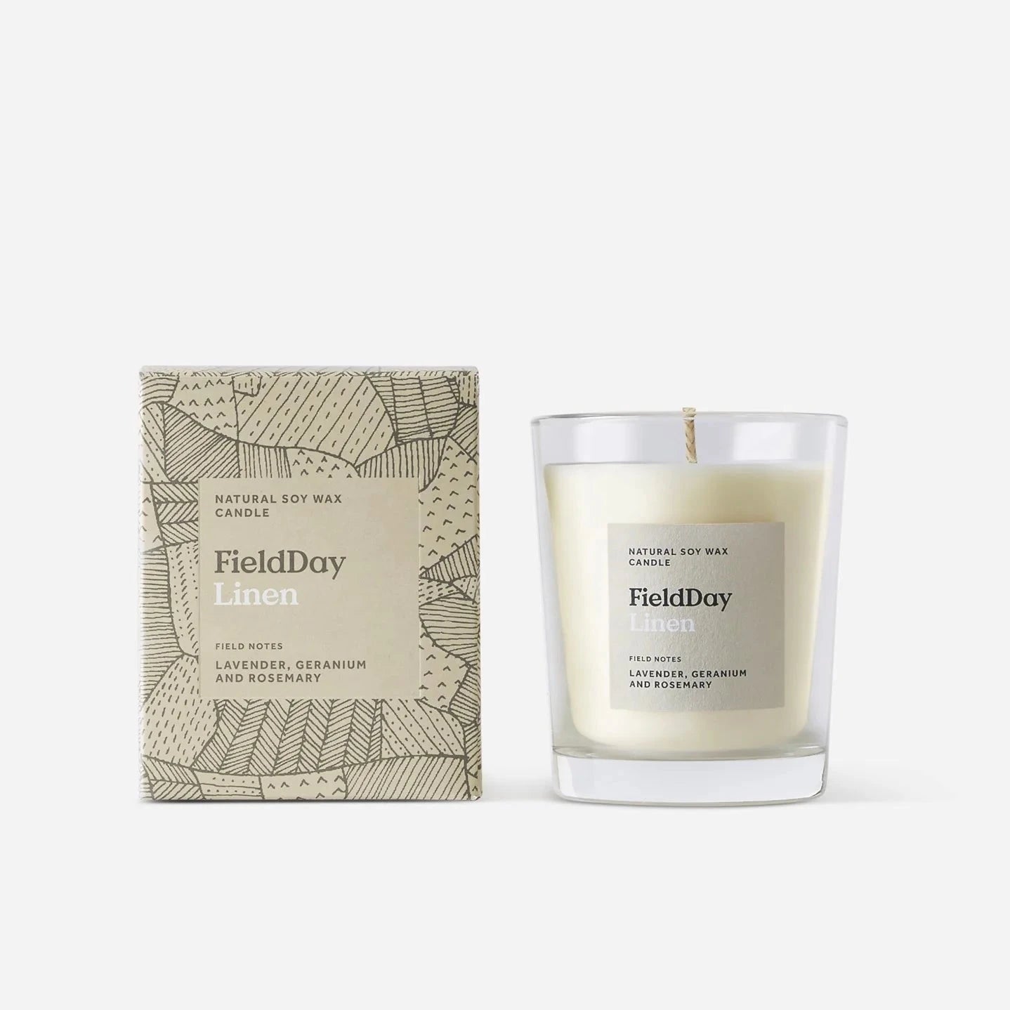 FieldDay Linen natural soy wax candle in a clear glass jar.  The label features a beige and brown geometric pattern.