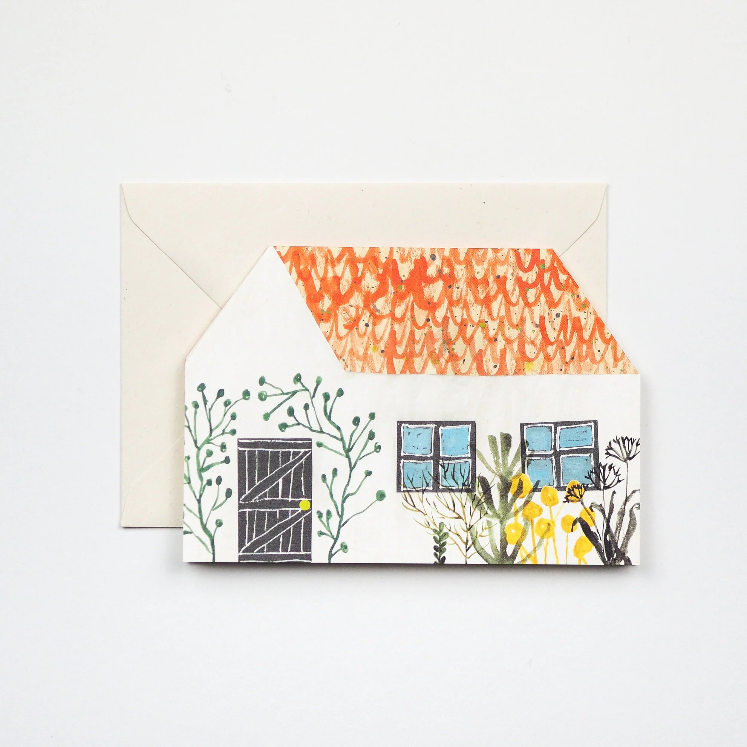 Illustrated card depicting a small house with an orange patterned roof, dark door, blue windows, and surrounding greenery.