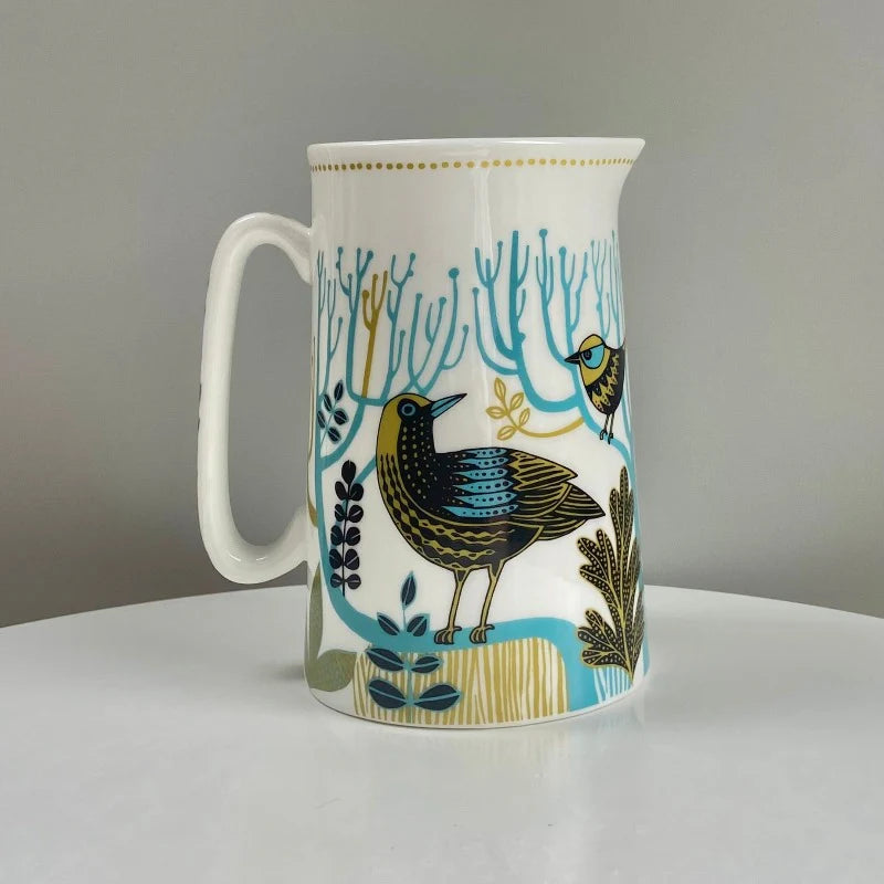 Mug with bird and nature design on a white surface