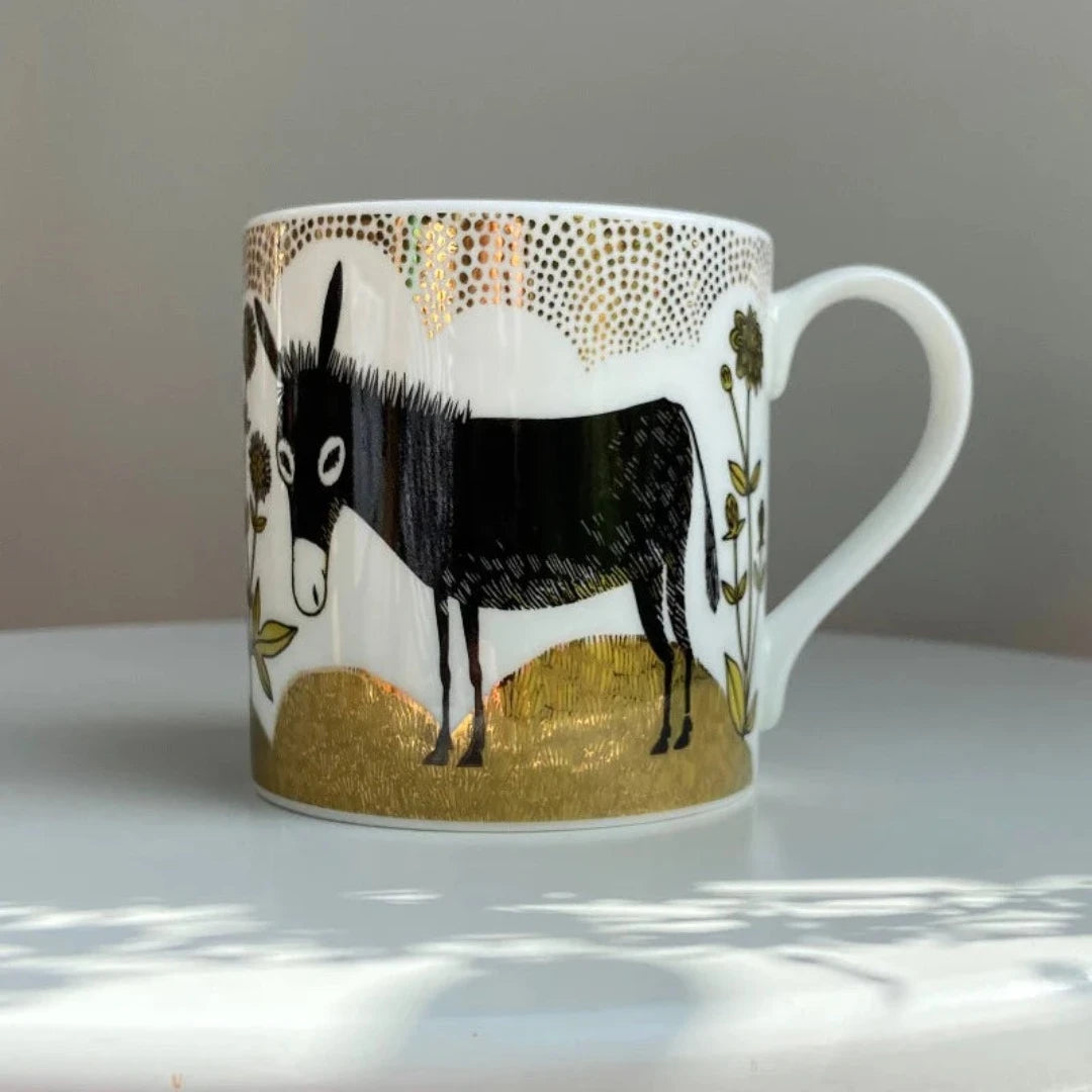 White mug with a black donkey illustration and gold accents.