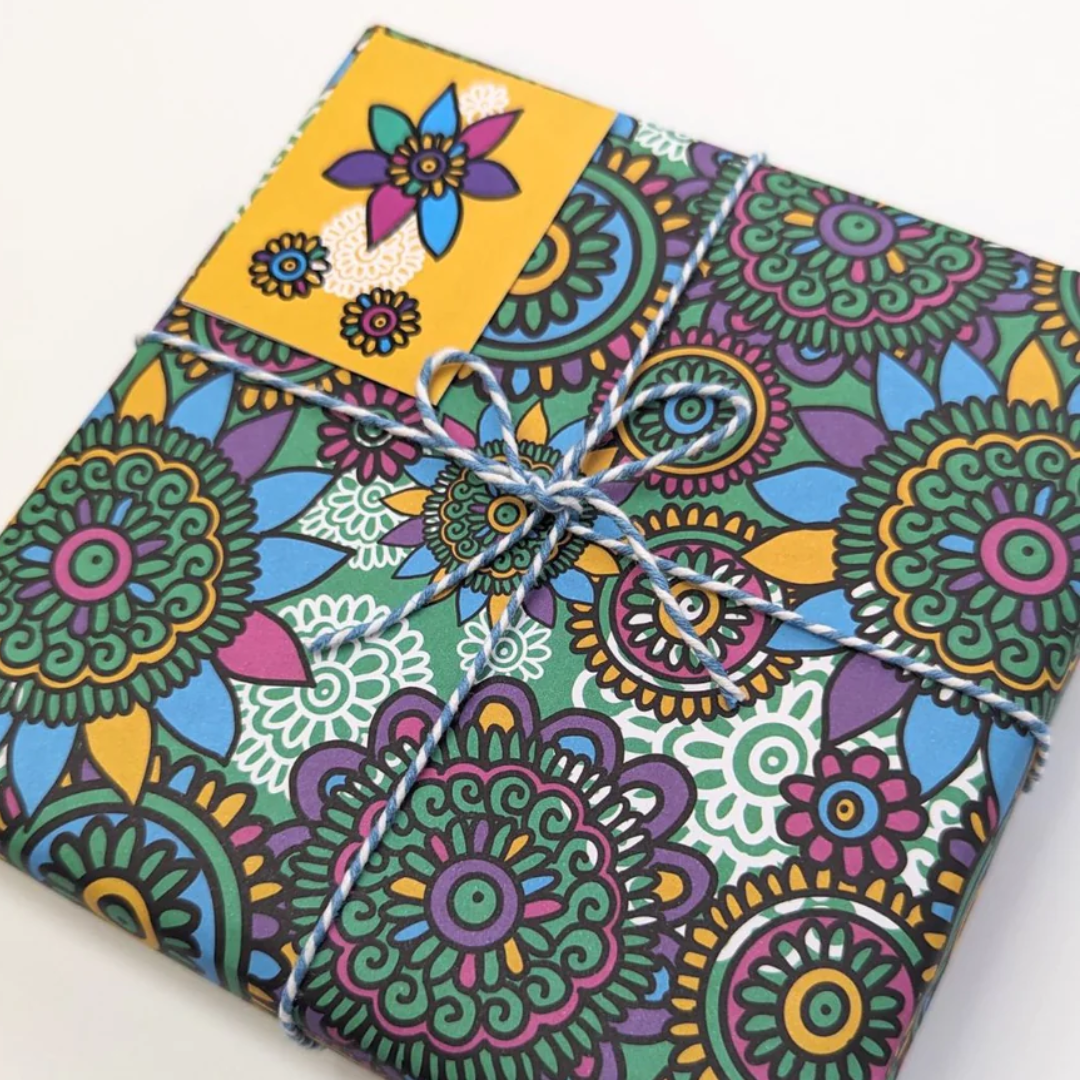 Gift wrapped in colorful floral patterned paper, tied with twine.